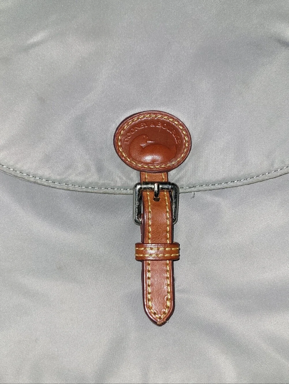 Dooney & Bourke Light Gray Nylon Backpack with Brown Leather Trim.